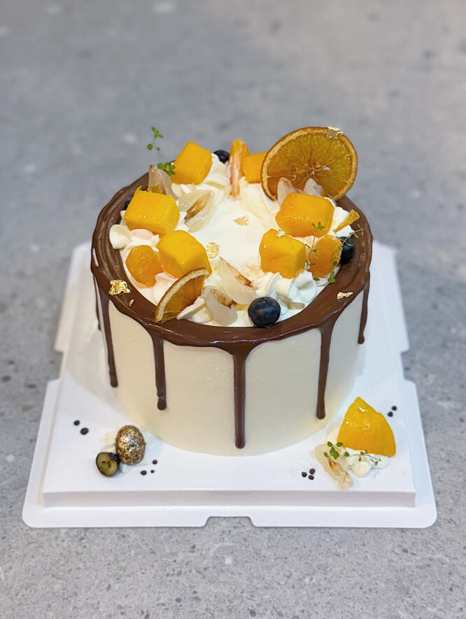 birthday cake with fresh mango and lychee and dark chocolate drizzle