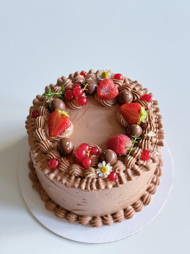 chocolate birthday cake with red currents and raspberries and strawberries