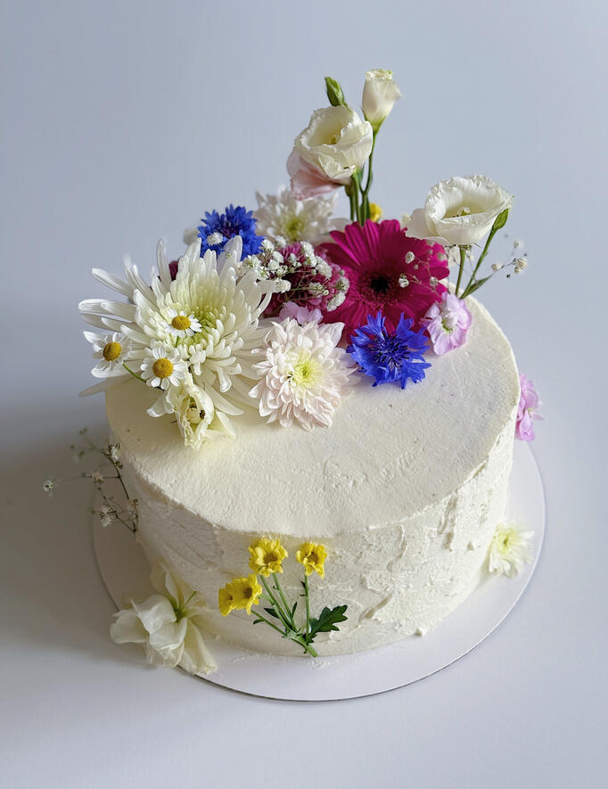 chocolate anniversary cake with vanilla frosting and flower decoration