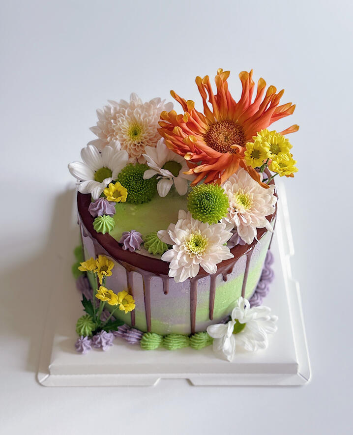 birthday layered cake with green and purple ombre and large flowers garden